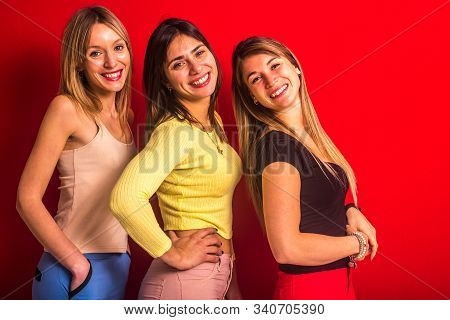 Three Girls Smiling One Behind The Other In Line