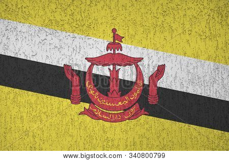 Brunei Darussalam Flag Depicted In Bright Paint Colors On Old Relief Plastering Wall. Textured Banne