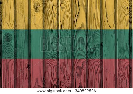 Lithuania Flag Depicted In Bright Paint Colors On Old Wooden Wall. Textured Banner On Rough Backgrou