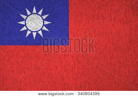 Taiwan Flag Depicted In Bright Paint Colors On Old Relief Plastering Wall. Textured Banner On Rough 