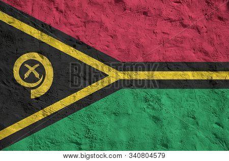 Vanuatu Flag Depicted In Bright Paint Colors On Old Relief Plastering Wall. Textured Banner On Rough