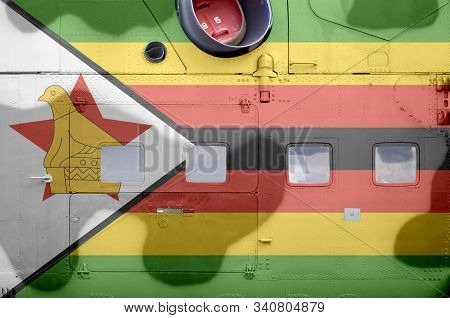 Zimbabwe Flag Depicted On Side Part Of Military Armored Helicopter Closeup. Army Forces Aircraft Con