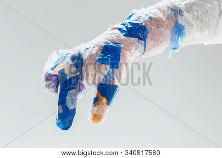 Big Plastic Hand Made Of Garbage Isolated On White Studio Background. The Result Of Polymers Overusi
