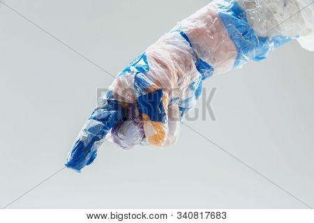 Big Plastic Hand Made Of Garbage Isolated On White Studio Background. The Result Of Polymers Overusi