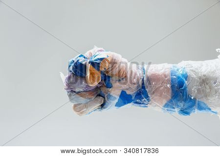 Big Plastic Hand Made Of Garbage Isolated On White Studio Background. The Result Of Polymers Overusi