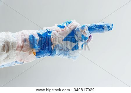 Big Plastic Hand Made Of Garbage Isolated On White Studio Background. The Result Of Polymers Overusi