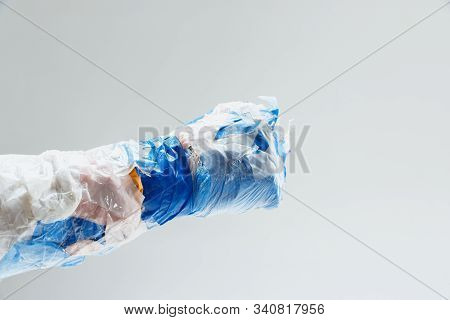 Big Plastic Hand Made Of Garbage Isolated On White Studio Background. The Result Of Polymers Overusi