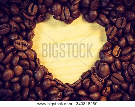 Roasted Brown Coffee Beans With Empty Heart Form Shape.