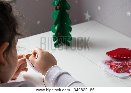 The Hand Of The Child Make Snowman And Christmas Tree With Needle, Thread For Christmas Greeting Car