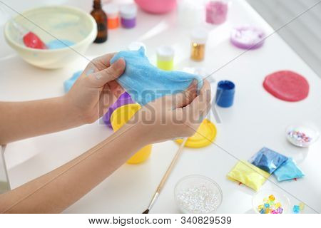Little Girl Making Diy Slime Toy At Table, Closeup
