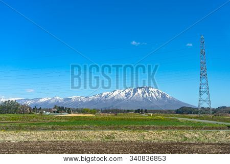 Snow Capped Mount Iwate With Clear Blue Sky Natural Background, Beauty Townscape Of Takizawa And Shi