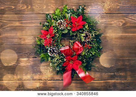 Amazing Christmas Wreath With Big Red Bow, Red Christmas Poinsettia Flowers And Holly Berries On Woo