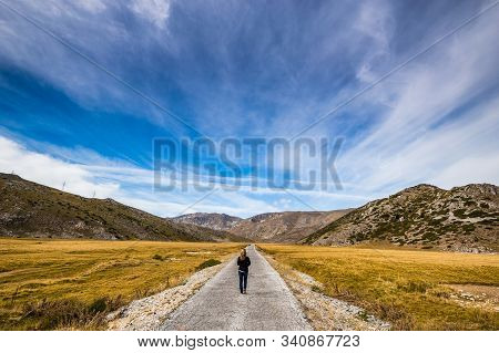Woman Walking On The Road In Mavrovo National Park - Mavrovo And Rostusa Municipality, North Macedon