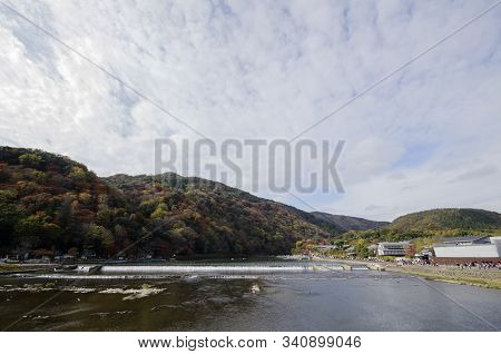 Katsuragawa River With Colourful Forest Mountain Background In Arashiyama District, Kyoto