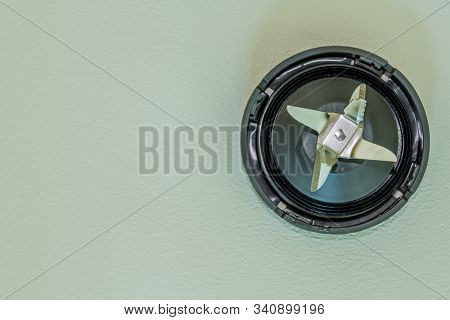Top Down View Of Blender Cutting Blades On Textured White Background.