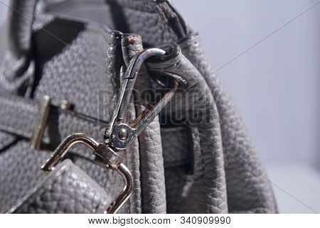 The Hook On The Edge Of The Gray Leather Bag.