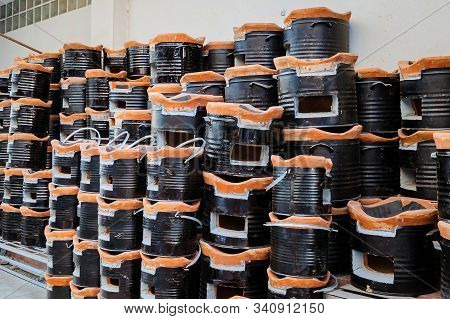 Many Ancient Charcoal Stoves Arranged In A Row Orderly For Sale To Asian Customers At The Grocery St