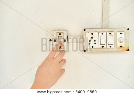 Female Hand, To Turn Off The Light, Switch, Front View.
