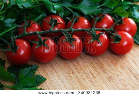 Fresh Vegetables On The Table. Food Background. Close Up. Cherry Tomatoes, A Bunch Of Parsley, Chopp
