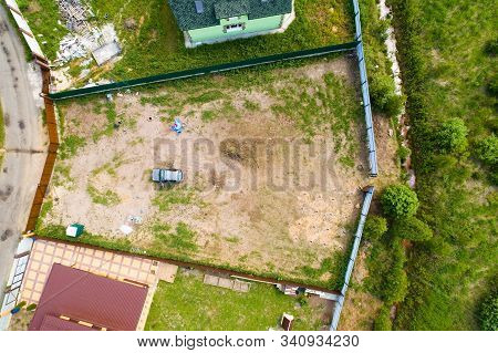 On The Countryside Private Plot There Is A Car And A Toilet Cubicle. Aerial Photography.