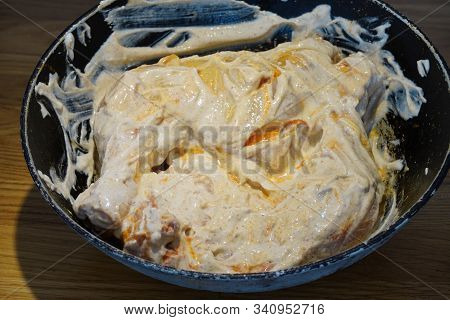 Cooking Chicken In White Sauce, In The Marinade. Smearing Dark Hands With Mayonnaise Or Seasonings C