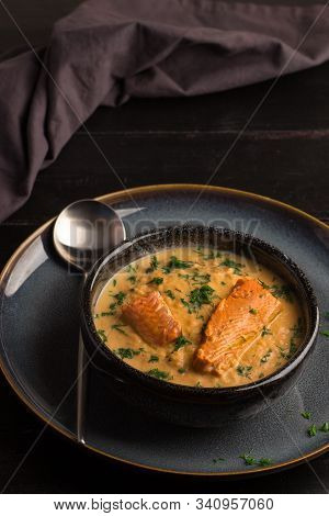 Salmon Creame Soupe In Bowl With Spoon On Wooden Table