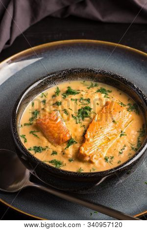 Salmon Creame Soupe In Bowl With Spoon On Wooden Table