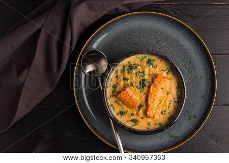 Salmon Creame Soupe In Bowl With Spoon On Wooden Table