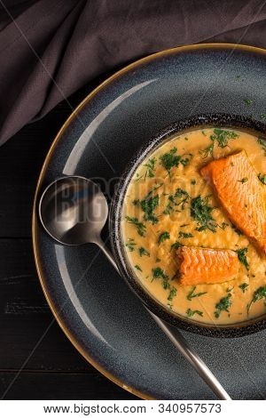 Salmon Creame Soupe In Bowl With Spoon On Wooden Table