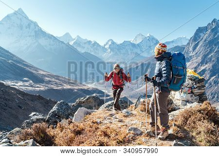 Couple Following Everest Base Camp Trekking Route Near Dughla 4620m. Backpackers Carrying Backpacks 