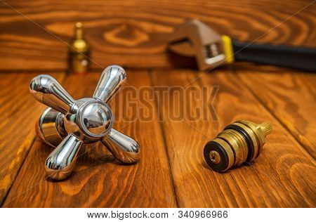 Cruciform Hot And Cold Water Main Switch Of Spare Parts On Vintage Wooden Boards