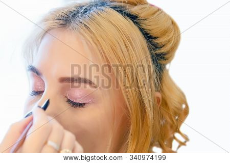Make-up Artist Doing Makeup For A Beautiful Young Red-haired Girl In A Beauty Salon, A Concept Of Pr