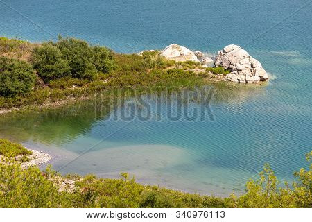 Scenic View At The Gadoura Water Reservoir On Rhodes Island, Greece With Blue And Turquoise Water An
