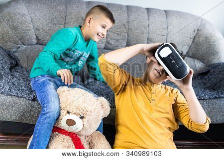 Cute, Little Boy Having Fun With Vr Headset With His Brother Next To Him And Teddy Bear Toy. Kids An