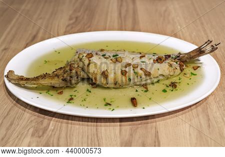 Bacalao With Pil Pil Sauce, Traditional Basque Dish With Salt Cod In Garlic-infused Oil With Dried G