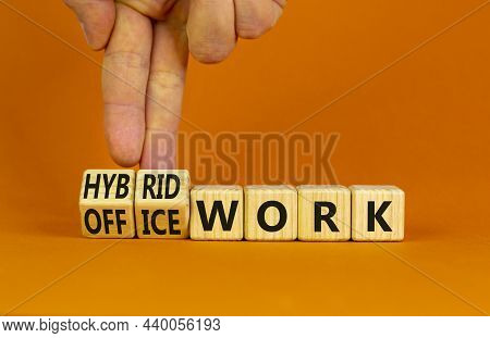 Hybrid Or Office Work Symbol. Businessman Turns Cubes And Changes Words 'office Work' To 'hybrid Wor