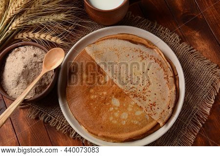 A Traditional French Savory Buckwheat Galettes Bretonnes Pancakes On A Table With  Flour, Wheat Plan