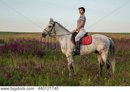 Horsewoman Jockey In Uniform Riding Horse Outdoors