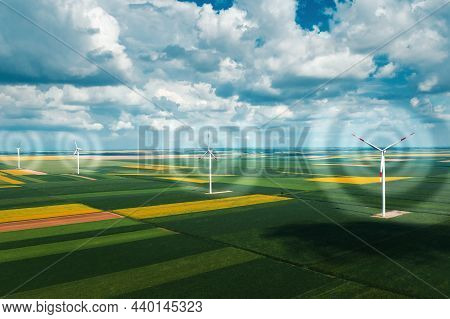 Aerial View Of Wind Turbines On Modern Wind Farm From Drone Pov, Digitally Enhanced Image High Angle