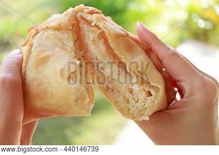Mouthwatering Empanadas De Jaiba Or Crab Meat Filled Chilean Puff Pastry In Woman's Hands