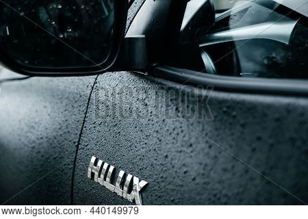 New Black Toyota Helix In Aggressive Tuning Is Parked On The Wet Ground Against The Background. A Re