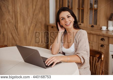 Attractive Young Freelancer Woman Using Laptop And Working At Home
