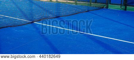 Blue Paddle Tennis Net And Court Field Background