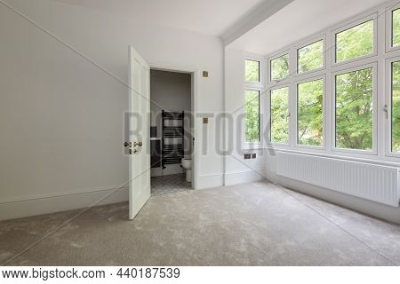 Wratting, England - August 19 2019: Empty  Bedroom Space With Door Opening Into Ensuite Closet Bathr