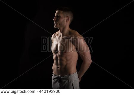 Man Showing Abs. Muscle Man Posing. Strong Body Concept. Topless Sport Man Bodybuilder. Six Pack Spo