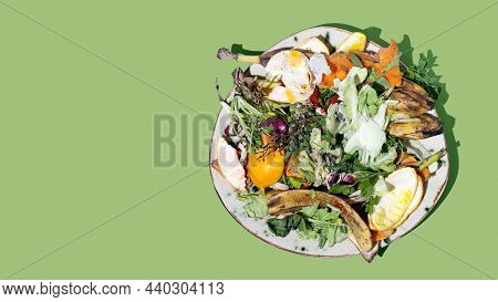 Reducing Food Waste Concept. Kitchen Leftovers From A Meal And Blemished Fruits And Vegetables On Pl