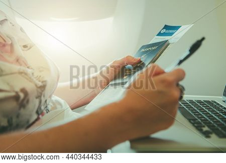 Caucasian Female American Tourist Inside Airplane With Passport And Us Customs And Border Protection