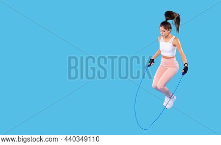 Young Sporty Girl Doing Jumping Rope Exercise At Gym On A Workout Session Wearing Comfortable Sports