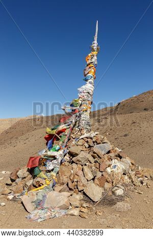 Gyu La Pass In The Himalayas. Traditional Pile Of Stones And Prayer Flags On The Mountain Pass. Must