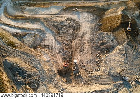 Aerial View Of Open Pit Mine Of Sandstone Materials For Construction Industry With Excavators And Du